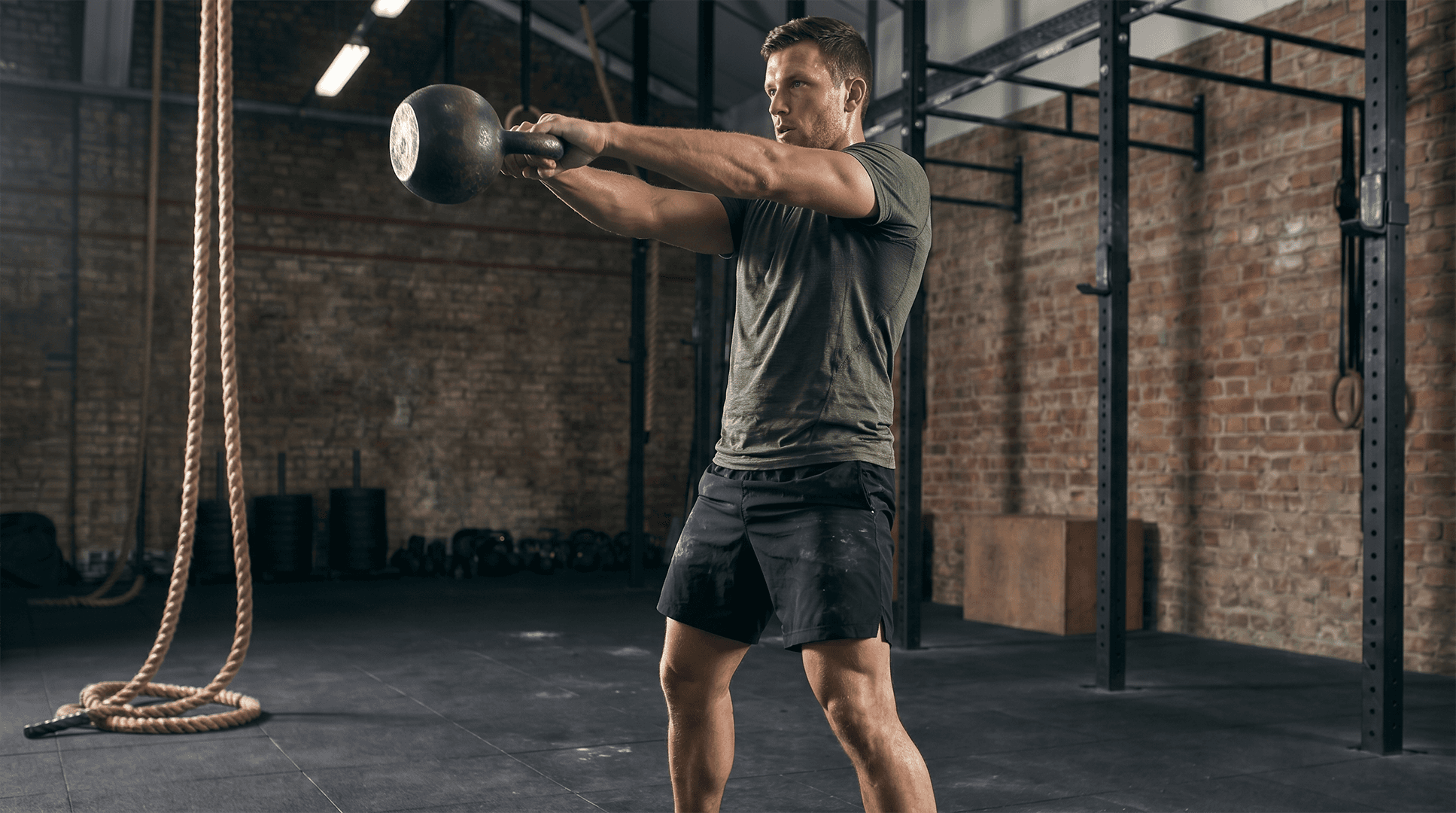 Man performing kettlebell swings